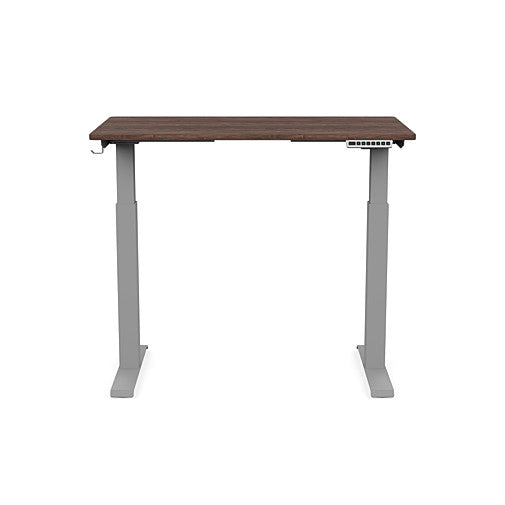 Front view of the SitonIt Switchback Height Adjustable Sit-to-Stand Desk. It has a Silver base with a 24"D x 42"W Walnut top - Kansas City Office Furniture