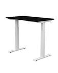 Back view of the SitonIt Switchback Height Adjustable Sit-to-Stand Desk. It has a White base with a 24"D x 42"W Black top - Kansas City Office Furniture
