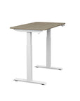 Side view of the SitonIt Switchback Height Adjustable Sit-to-Stand Desk. It has a White base with a 24"D x 42"W Sandalwood top - Kansas City Office Furniture