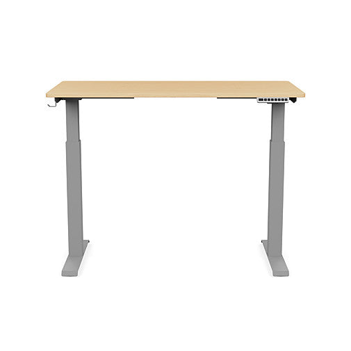 Front view of the SitonIt Switchback Height Adjustable Sit-to-Stand Desk. It has a Silver base with a 24"D x 48"W Maple top - Kansas City Office Furniture