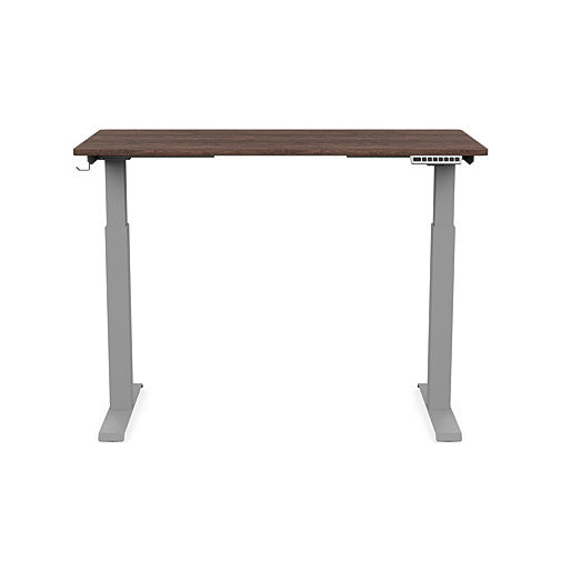 Front view of the SitonIt Switchback Height Adjustable Sit-to-Stand Desk. It has a Silver base with a 24"D x 48"W Walnut top - Kansas City Office Furniture