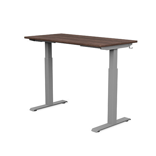 Back view of the SitonIt Switchback Height Adjustable Sit-to-Stand Desk. It has a Silver base with a 24"D x 48"W Walnut top - Kansas City Office Furniture