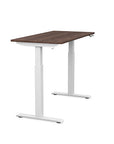 Side view of the SitonIt Switchback Height Adjustable Sit-to-Stand Desk. It has a White base with a 24"D x 48"W Walnut top - Kansas City Office Furniture