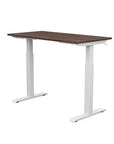 Back view of the SitonIt Switchback Height Adjustable Sit-to-Stand Desk. It has a White base with a 24"D x 48"W Walnut top - Kansas City Office Furniture
