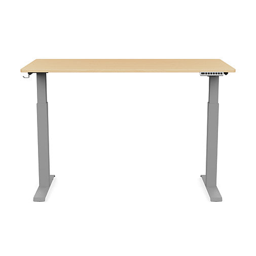 Front view of the SitonIt Switchback Height Adjustable Sit-to-Stand Desk. It has a Silver base with a 27"D x 54"W Maple top - Kansas City Office Furniture
