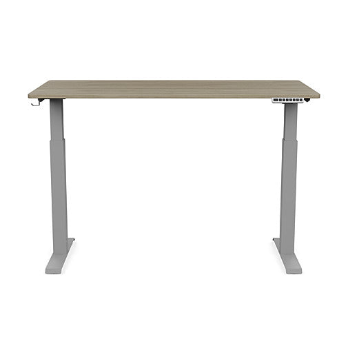 Front view of the SitonIt Switchback Height Adjustable Sit-to-Stand Desk. It has a Silver base with a 27"D x 54"W Sandalwood top - Kansas City Office Furniture