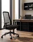 Modern office setup with a black chair and desk in a bright room. Kansas City Office Design