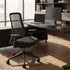 Modern office desk with chair, computer setup, and decor in a bright room. Kansas City Office Design.