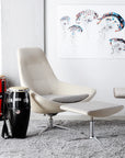 Modern Via Astro Lounge chair with two drums on a gray carpet, colorful abstract art on the wall. Kansas City Office Design.