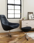 Modern black Via Astro Lounge chair and ottoman in a room with a dresser and window. Kansas City Office Design.