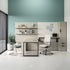 Modern office setup with desks, chairs, and decor against a teal wall. Kansas City Office Design.