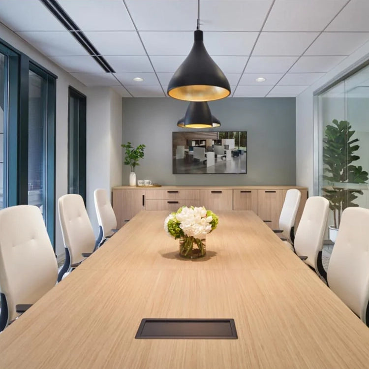 Modern conference room with a long wooden table, white chairs, and decorative elements. Kansas City Office Design.