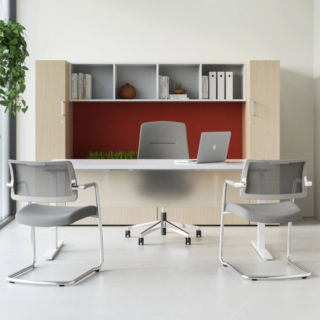 Modern office setup with a desk, chairs, and bookshelf. Kansas City Office Design.