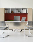Modern office setup with a desk, chairs, and bookshelf. Kansas City Office Design.