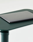 Forest Green adjustable Humanscale Float micro desk with a laptop on a white background. Kansas City Office Design.