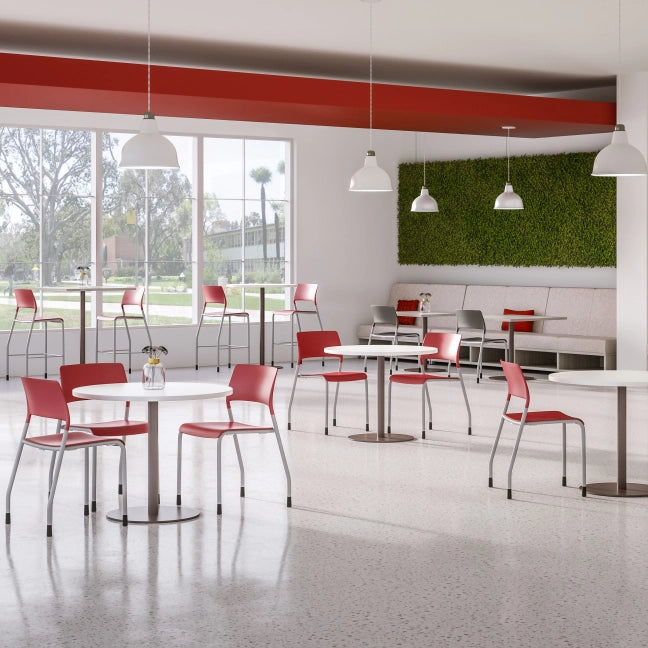Modern cafe interior with red chairs and white tables near large windows. Kansas City Office Design
