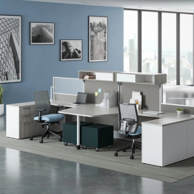 Modern office setup with desks, chairs, and wall art in a bright room. Kansas City Office Design