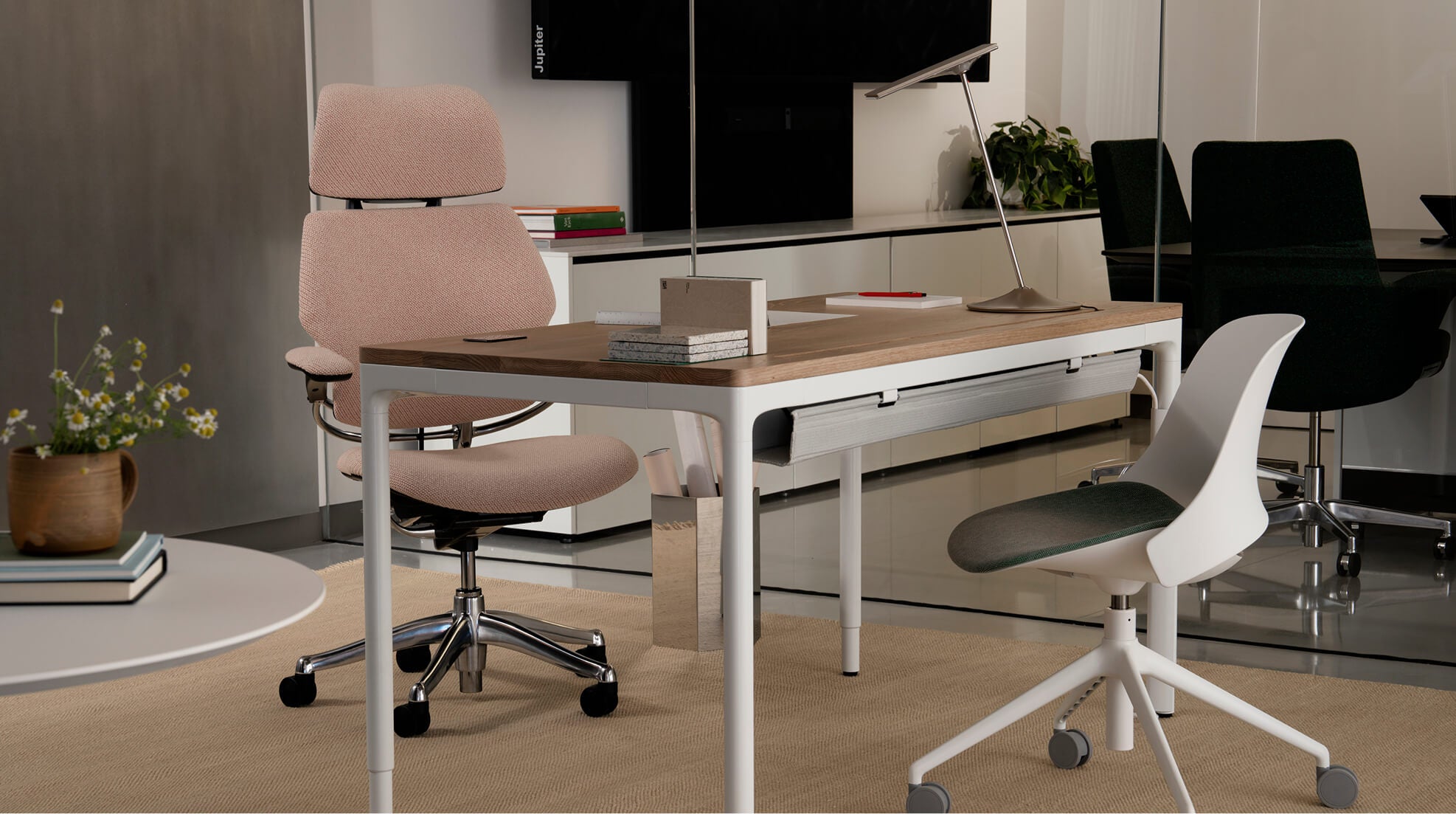 Modern office setup with a Humanscale eFloat Quattro desk, chairs, and decor in a professional setting. Kansas City Office Design.