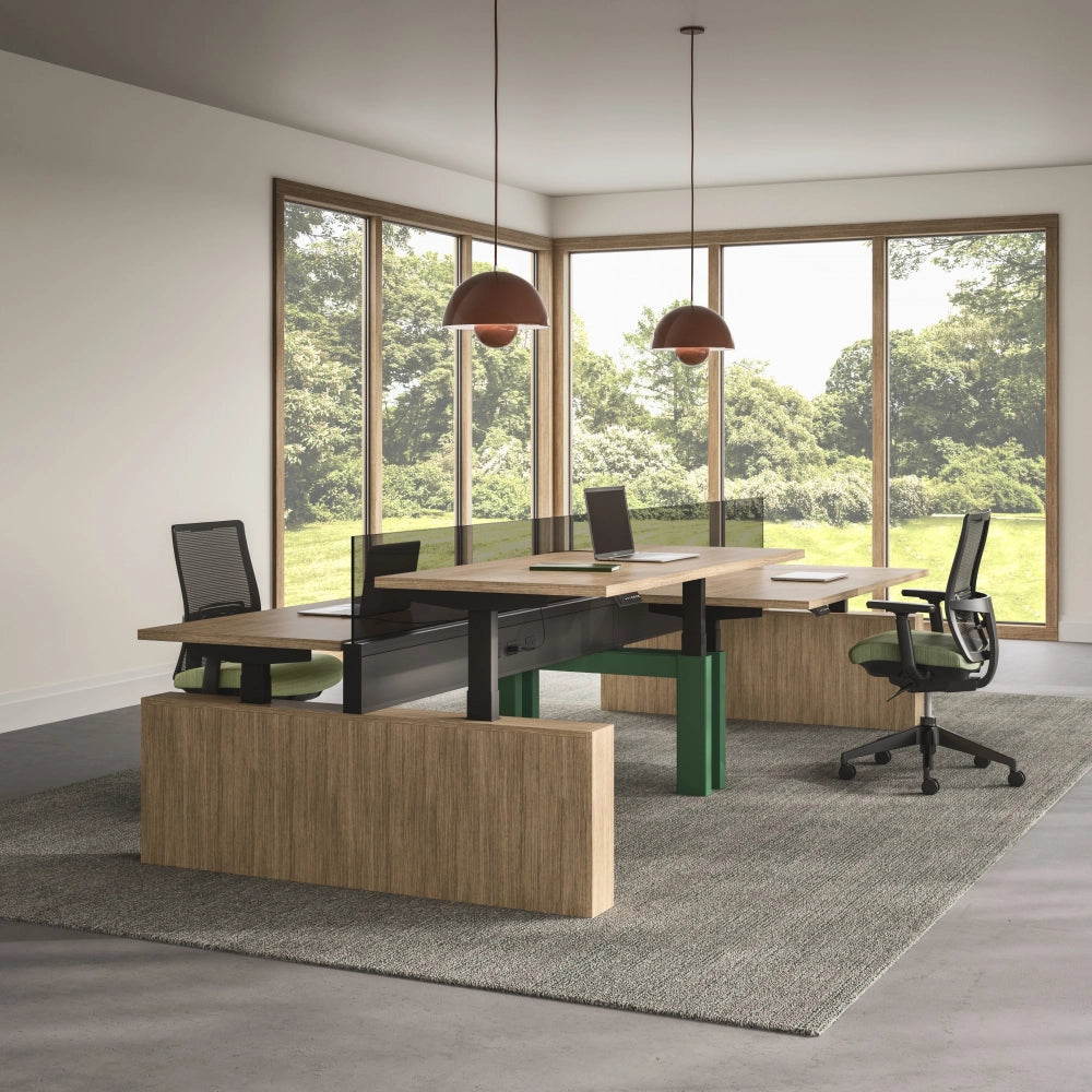 Modern office setup with a Power bench sit to stand desk and chairs in a room with large windows. Kansas City Office Design.