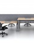 Two power bench sit to stand office desks with chairs and laptops in a minimalistic office setting. Configured in a back to back layout. Kansas City Office Design.