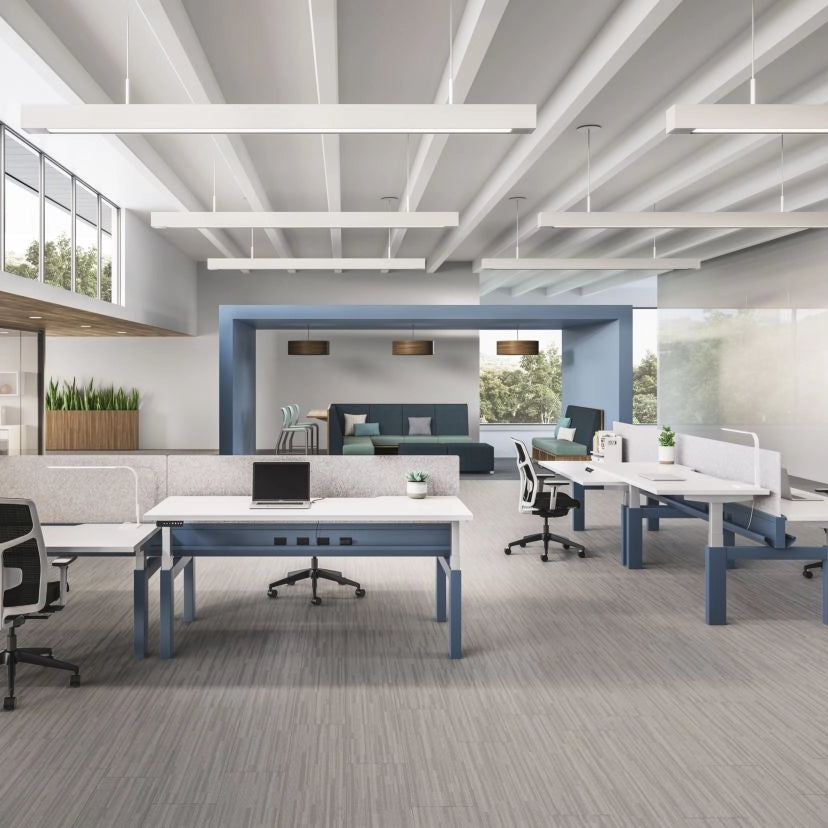 Modern office space with power bench sit to stand desks, chairs, and a large window. Kansas City Office Design.