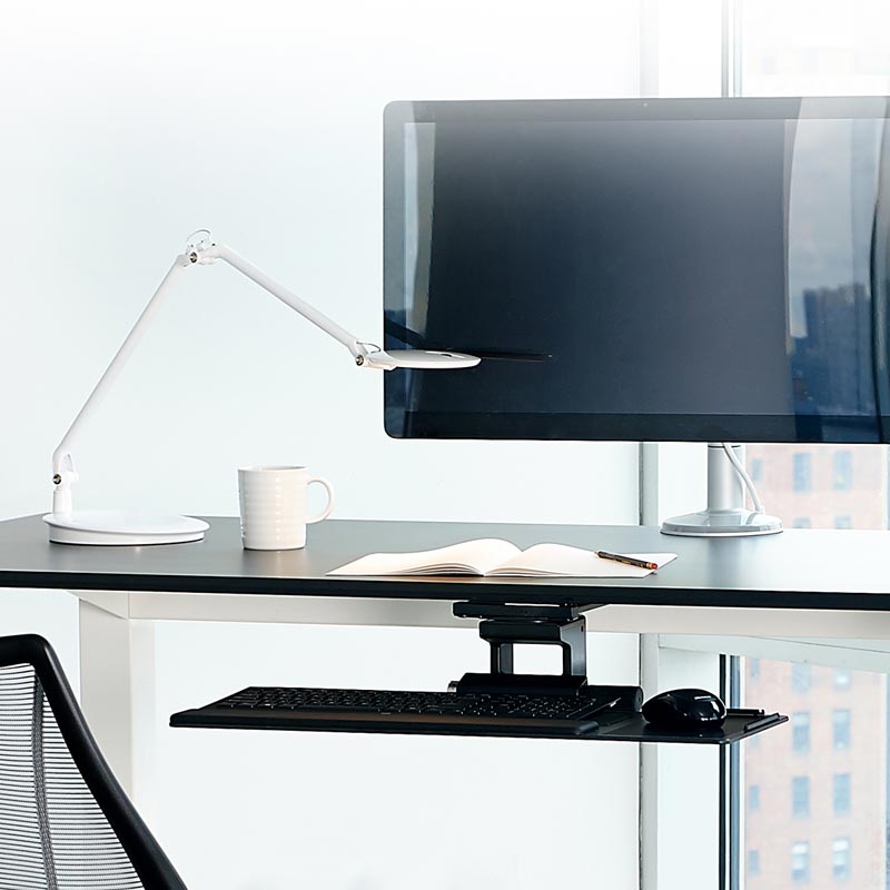 Modern Office with HumanScale keyboard tray meant for height adjustable desk. Pictured with a desk, chair. Kansas City Office Design.