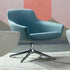 Modern blue Gobi lounge chair with a star-shaped base on a textured floor. Kansas City Office Design.