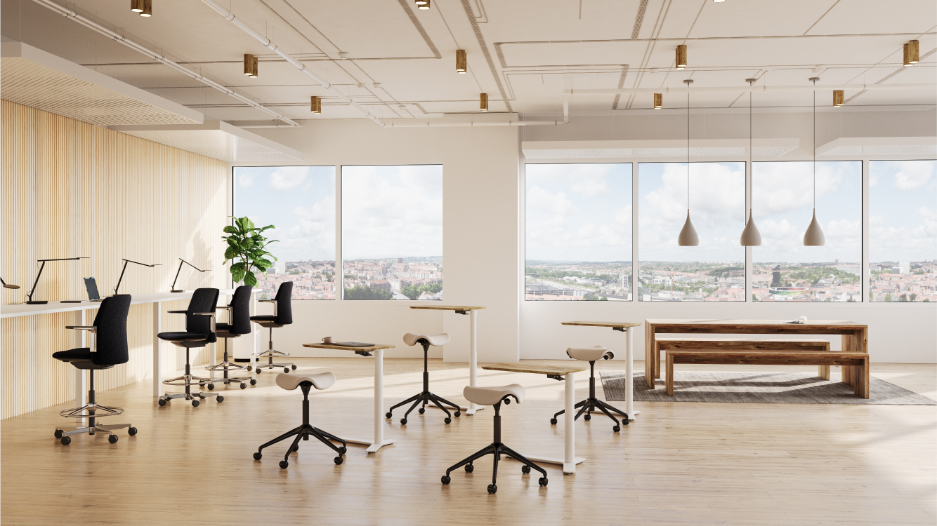 Modern office space with Humanscale mini float height adjustable desks, saddle stools, and large windows. Kansas City Office Design.