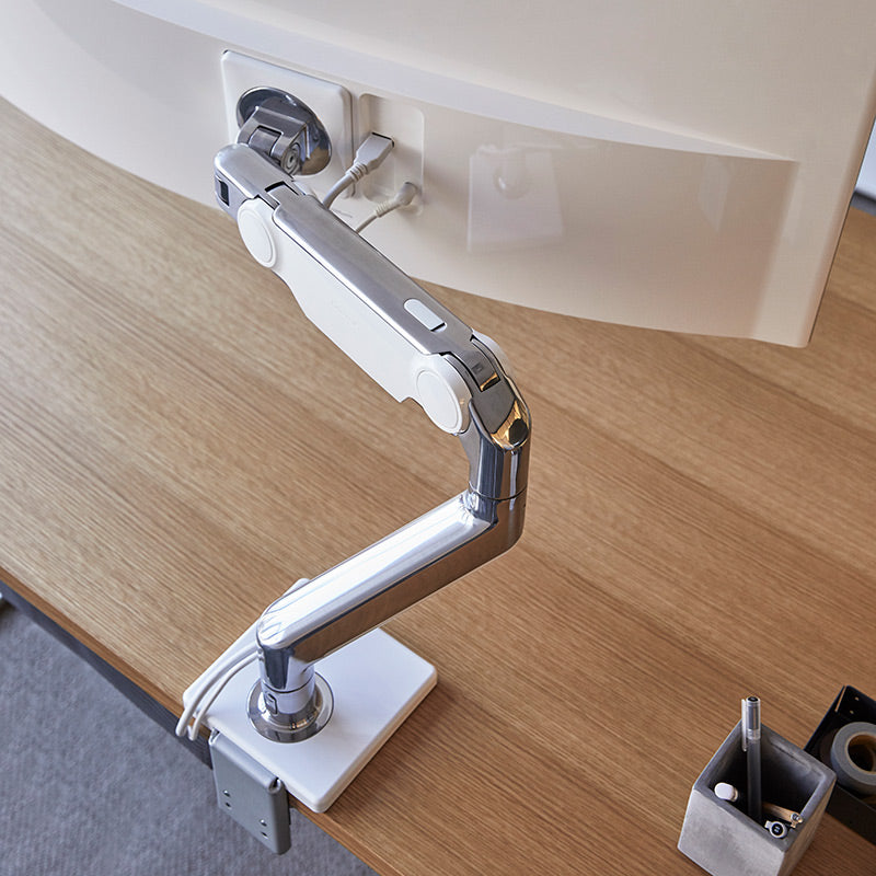 Top view of a Humanscale M10 single monitor arm on desk. Kansas City Office Design.