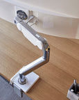 Top view of a Humanscale M10 single monitor arm on desk. Kansas City Office Design.