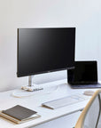 Humanscale M2.1 single monitor arm installed on modern desk. Kansas City Office Design.