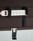 Closeup of the Humanscale NeatTech Cable Management tray with a Power strip with multiple outlets attached to a brown surface using black straps. Kansas City Office Furniture