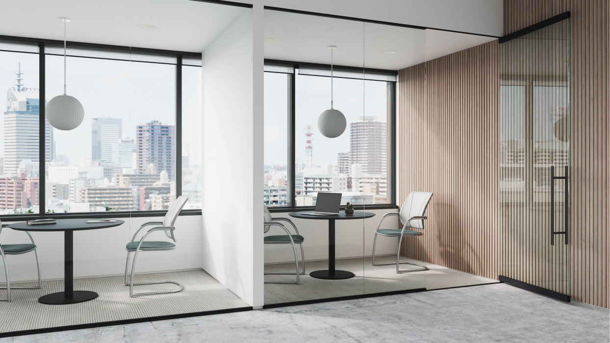 Modern office space with large windows and glass walls. Includes the 36" Round Humanscale Float Gather table. Kansas City Office Design.