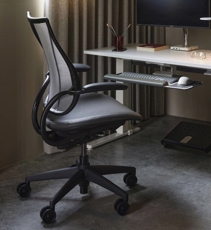 Ergonomic Humanscale Liberty office chair in front of a desk with computer setup. Kansas City Office Design.