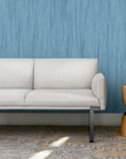 Gray SitOnIt Cameo sofa in a room with blue textured wallpaper and a wooden side table. Kansas City Office Design