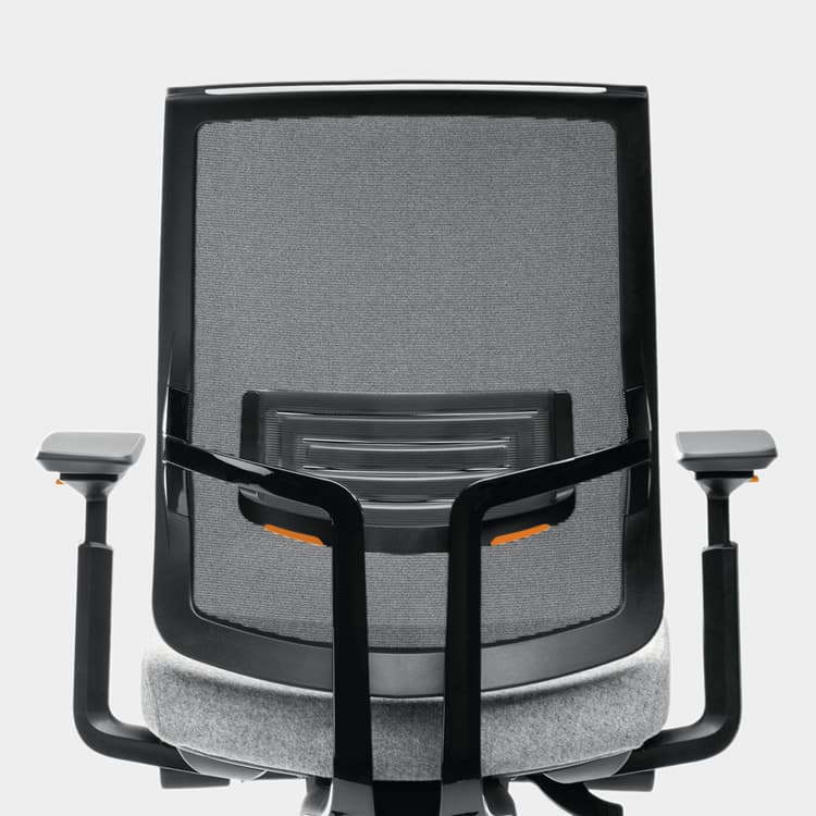 Ergonomic office chair with mesh backrest and armrests on a light gray background. Kansas City Office Design