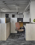 Modern office space with cubicles and a chair. Kansas City Office Design