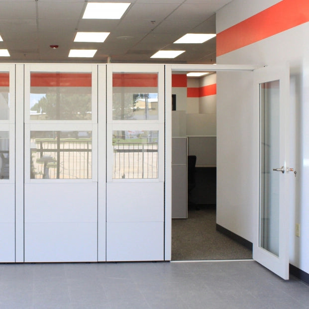Modern office space with glass partitions and red accents. Kansas City Office Design