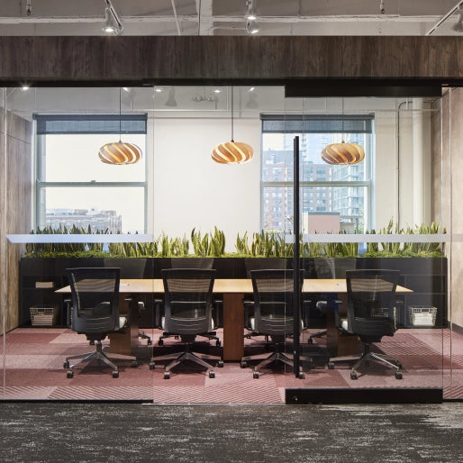 Modern office interior with glass walls, desks, and chairs. Kansas City Office Design.
