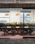 Modern office interior with glass walls, desks, and chairs. Kansas City Office Design.