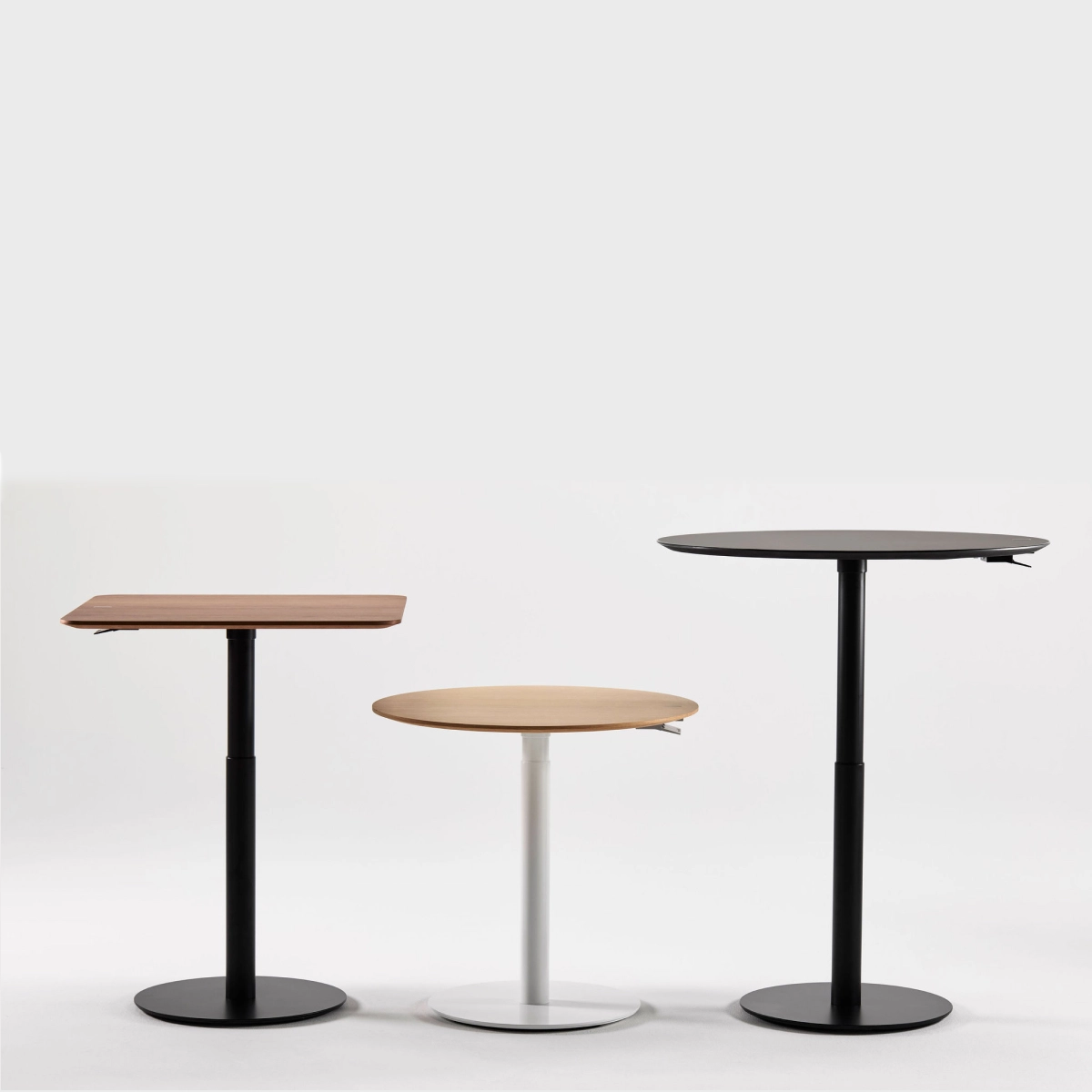 Three Humanscale Height Adjustable Float Gather tables (30" Round, 36" Round, 30" Square) with different designs on a white background. Kansas City Office Design.