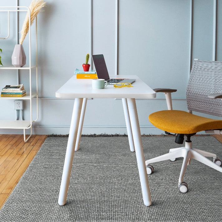 Modern office setup with a white SitonIt Reya desk, chair, and decor items. Kansas City Office Design.