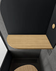 Inside view of the Black Room Phone Booth, a soundproof privacy pod with a built-in desk. Kansas City Office Furniture