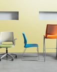 Three colorful chairs against a yellow wall. Kansas City Office Design.