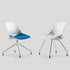 Two modern chairs with one having a blue seat on a light gray background. Kansas City Office Design