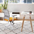 Modern Home Wit office chair with orange seat in a bright room with a desk and plants. Kansas City Office Design.